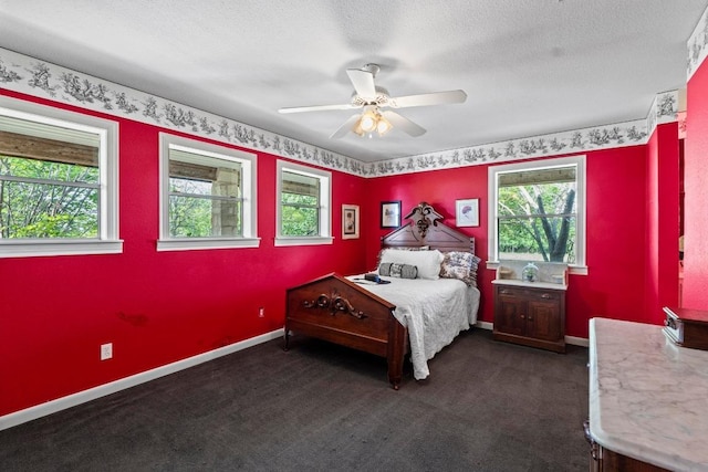 bedroom featuring a ceiling fan, baseboards, and dark colored carpet