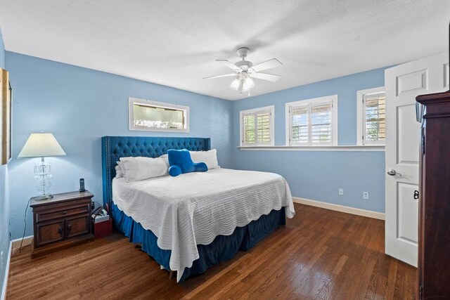 bedroom featuring a ceiling fan, baseboards, and wood finished floors