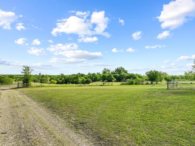 view of yard featuring fence and a rural view