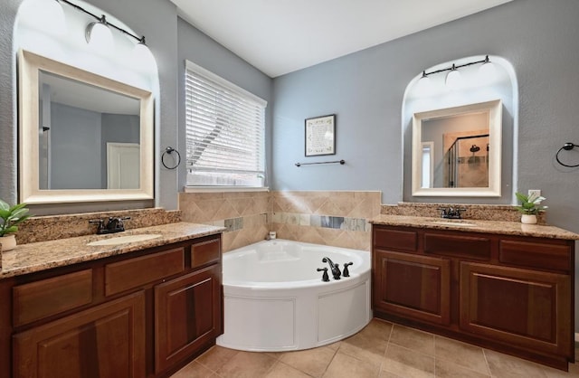 7716 Journeyville Dr, Austin, TX 78735 - bathroom with two vanities, a bath, a stall shower, and tile patterned flooring