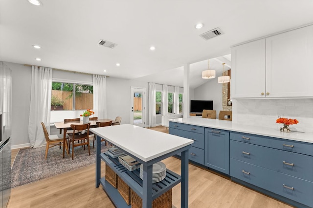 4302 Red Cloud Dr, Austin, TX 78759 - kitchen with white cabinetry, light wood-type flooring, tasteful backsplash, recessed lighting, and light countertops