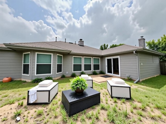 3622 Cheyenne St, Round Rock, TX 78664 - rear view of house with a chimney, a lawn, and a patio area