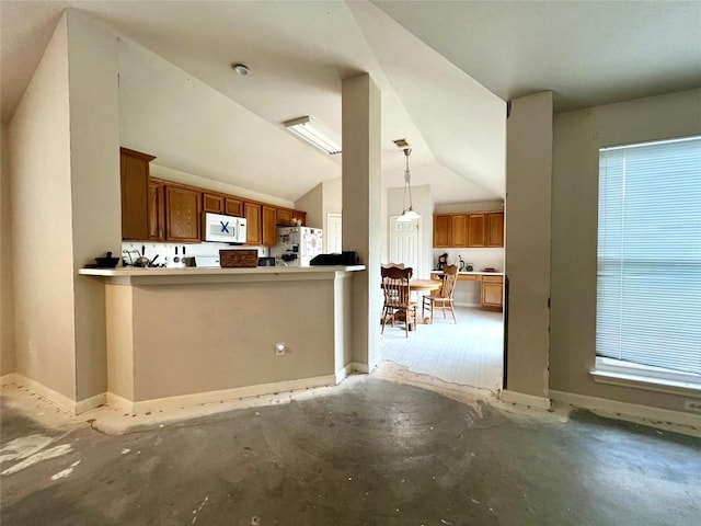 3622 Cheyenne St, Round Rock, TX 78664 - kitchen with white appliances, brown cabinetry, lofted ceiling, hanging light fixtures, and a peninsula