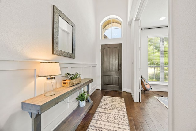 5609 Traviston Ct, Austin, TX 78738 - entryway with dark wood-type flooring, a decorative wall, and wainscoting