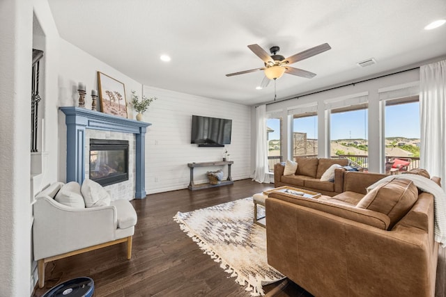 5609 Traviston Ct, Austin, TX 78738 - living room featuring recessed lighting, a ceiling fan, a tiled fireplace, and dark wood-style floors