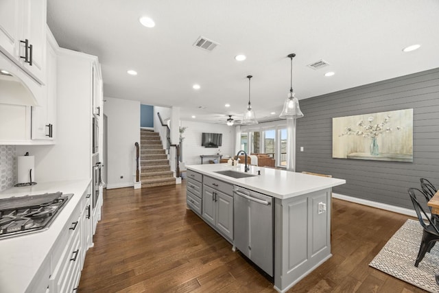5609 Traviston Ct, Austin, TX 78738 - kitchen featuring appliances with stainless steel finishes, open floor plan, gray cabinetry, an island with sink, and recessed lighting