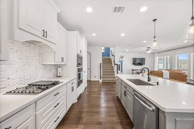5609 Traviston Ct, Austin, TX 78738 - kitchen featuring stainless steel appliances, open floor plan, recessed lighting, light countertops, and dark wood-style floors