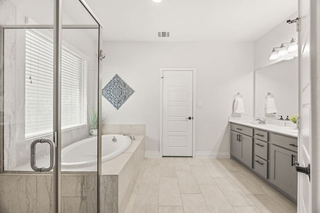 5609 Traviston Ct, Austin, TX 78738 - bathroom featuring double vanity, a garden tub, and a shower stall