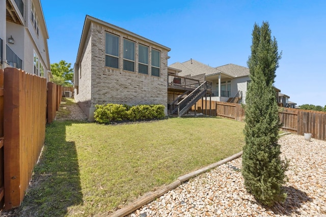 5609 Traviston Ct, Austin, TX 78738 - rear view of house with brick siding, stairs, a fenced backyard, and a wooden deck