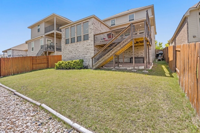 5609 Traviston Ct, Austin, TX 78738 - back of house with stairway, a fenced backyard, brick siding, and a wooden deck