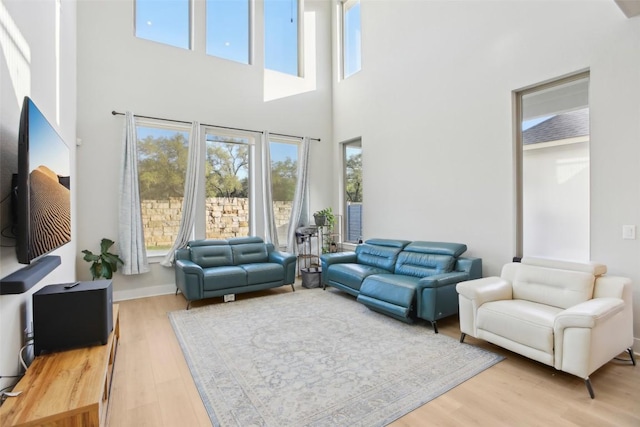 244 Diamondback Dr, Georgetown, TX 78628 - living area with a towering ceiling, healthy amount of natural light, and wood finished floors