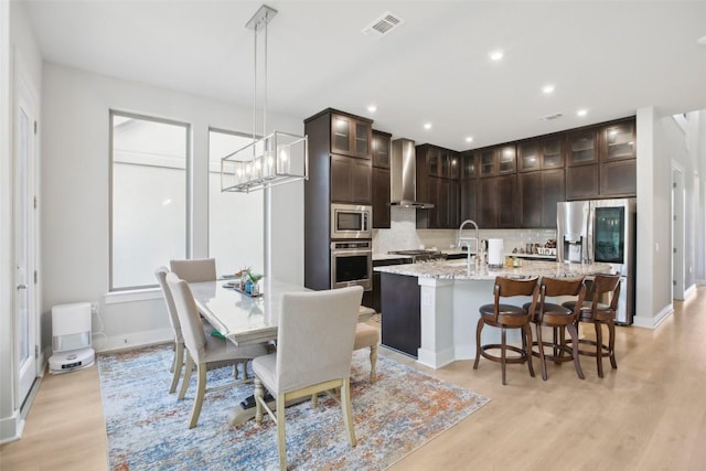 244 Diamondback Dr, Georgetown, TX 78628 - dining room with light wood-style floors, baseboards, recessed lighting, and a chandelier