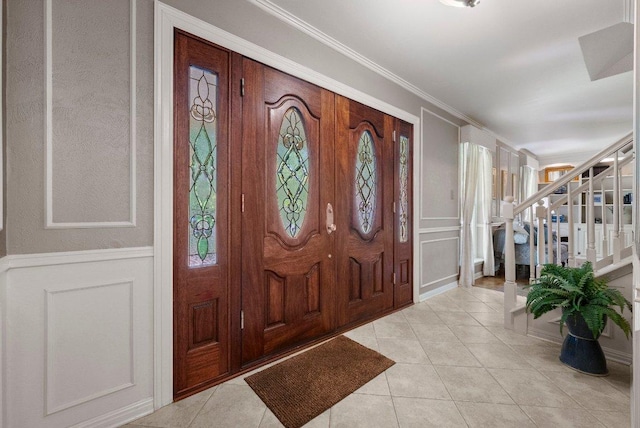 4101 Galacia Dr, Austin, TX 78759 - entrance foyer with a decorative wall, stairs, light tile patterned floors, and crown molding