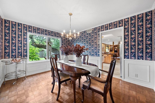 4101 Galacia Dr, Austin, TX 78759 - dining space with wallpapered walls, a chandelier, wainscoting, and crown molding