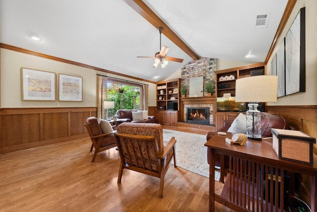 4101 Galacia Dr, Austin, TX 78759 - living room with light wood-type flooring, a brick fireplace, wainscoting, a ceiling fan, and built in features