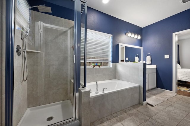 1404 Jenkins Bnd Unit 11, Austin, TX 78748 - full bath featuring a stall shower, vanity, a garden tub, and tile patterned floors