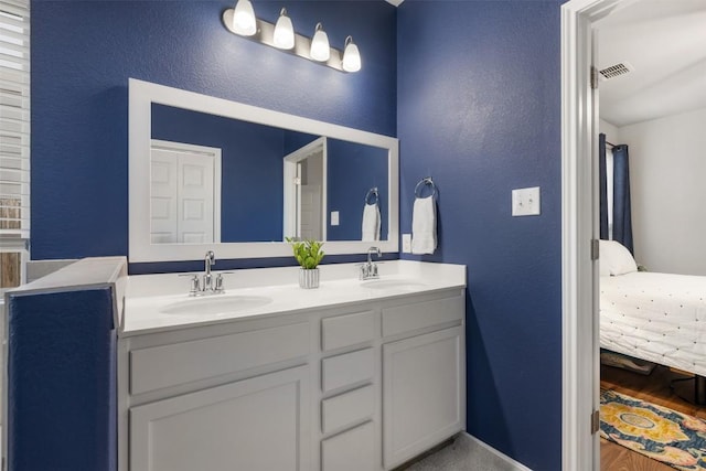 1404 Jenkins Bnd Unit 11, Austin, TX 78748 - bathroom featuring ensuite bathroom, a textured wall, double vanity, and wood finished floors