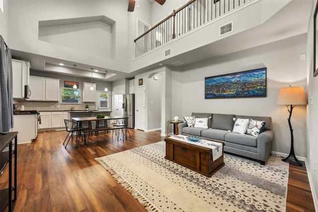 1404 Jenkins Bnd Unit 11, Austin, TX 78748 - living area featuring a ceiling fan, dark wood-type flooring, a towering ceiling, and recessed lighting