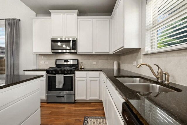 1404 Jenkins Bnd Unit 11, Austin, TX 78748 - kitchen featuring appliances with stainless steel finishes, white cabinets, tasteful backsplash, and dark wood finished floors