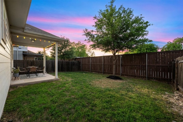 1404 Jenkins Bnd Unit 11, Austin, TX 78748 - yard at dusk with a patio and a fenced backyard