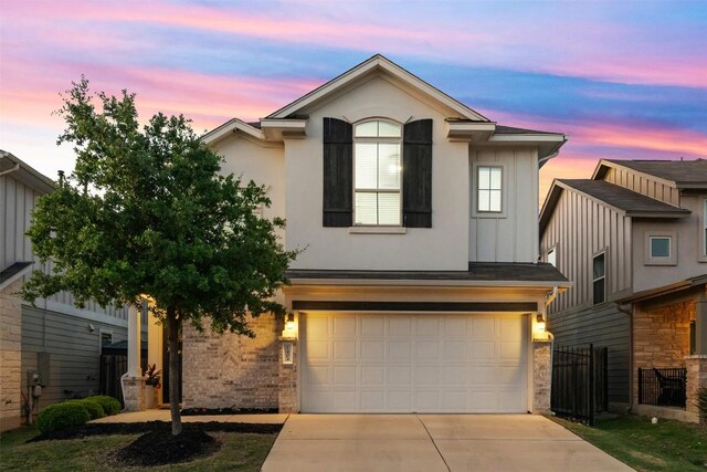1404 Jenkins Bnd Unit 11, Austin, TX 78748 - view of front of house with a garage, driveway, brick siding, and board and batten siding