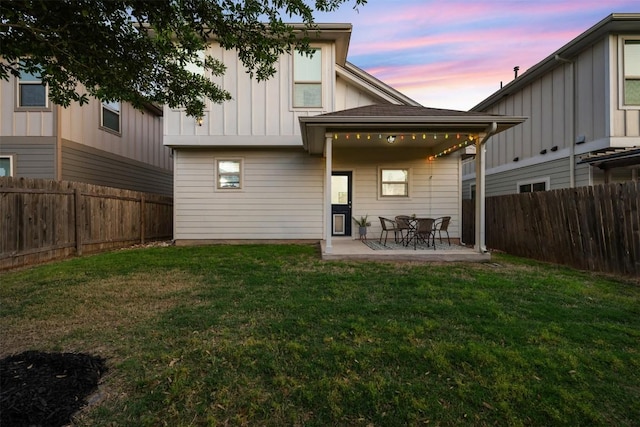 1404 Jenkins Bnd Unit 11, Austin, TX 78748 - back of property at dusk featuring board and batten siding, a patio area, and a fenced backyard