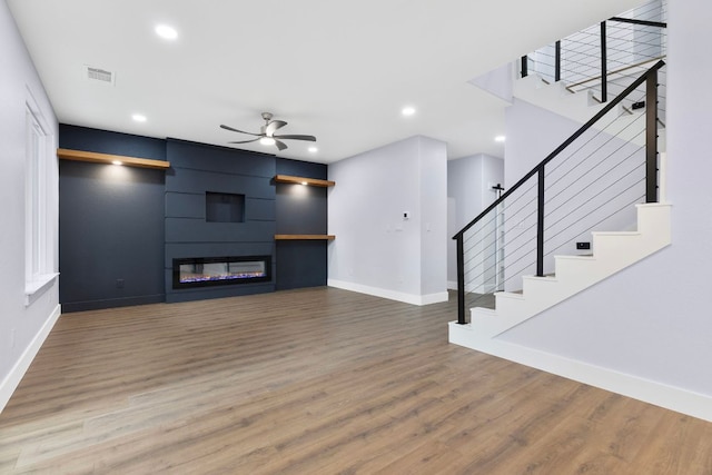 unfurnished living room with recessed lighting, wood finished floors, visible vents, baseboards, and ceiling fan
