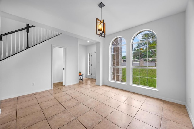 104 Summerwood Cv, San Marcos, TX 78666 - unfurnished dining area featuring tile patterned floors, baseboards, and a chandelier