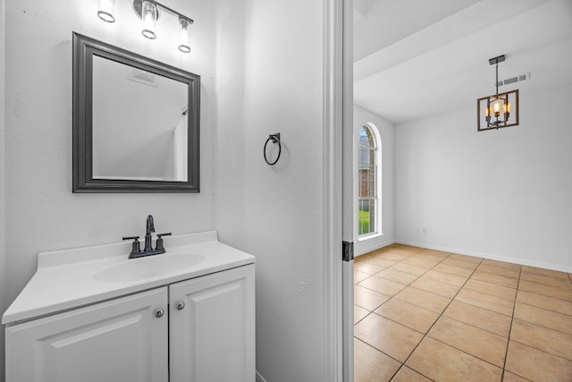 104 Summerwood Cv, San Marcos, TX 78666 - bathroom with vanity, tile patterned flooring, a chandelier, and baseboards