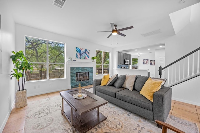 104 Summerwood Cv, San Marcos, TX 78666 - living area featuring ceiling fan, light tile patterned flooring, healthy amount of natural light, and baseboards