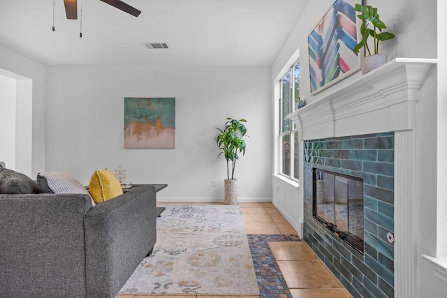104 Summerwood Cv, San Marcos, TX 78666 - tiled living area featuring ceiling fan, a tile fireplace, and baseboards
