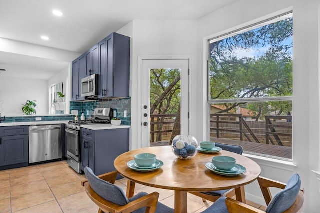 104 Summerwood Cv, San Marcos, TX 78666 - kitchen with stainless steel appliances, decorative backsplash, light countertops, light tile patterned floors, and recessed lighting