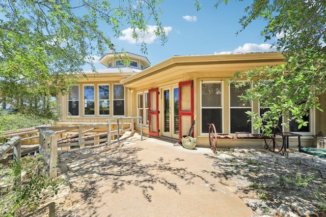 rear view of property featuring a patio and french doors