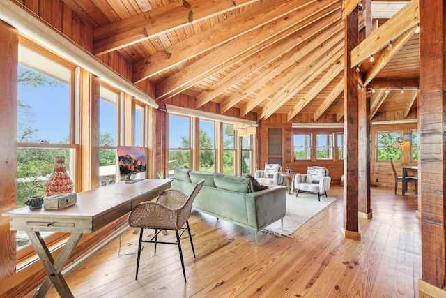living room featuring wood ceiling, lofted ceiling with beams, and light wood finished floors