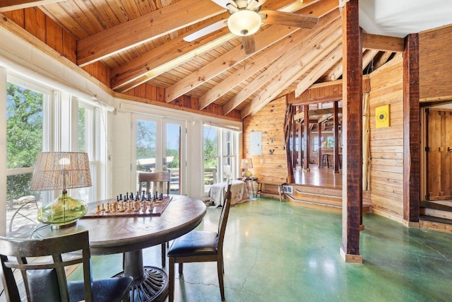 sunroom with beamed ceiling, plenty of natural light, and french doors