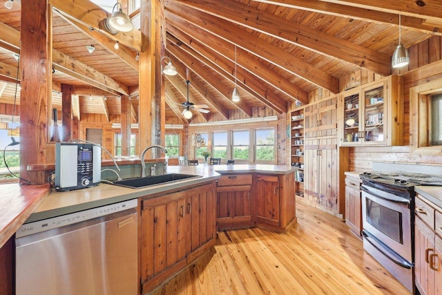 kitchen with stainless steel appliances, wooden ceiling, brown cabinetry, a sink, and light wood-style flooring