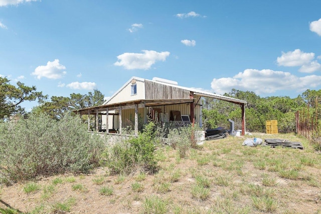back of property with an outdoor structure