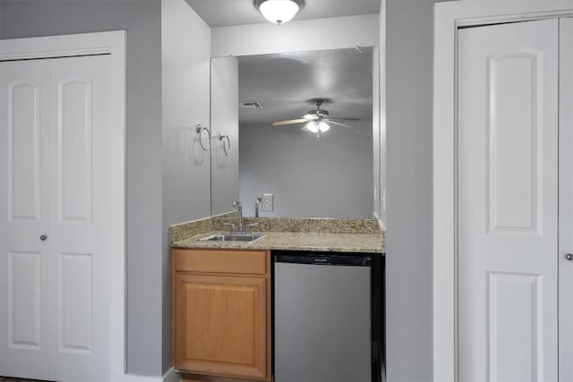 kitchen featuring dishwasher, visible vents, a sink, light stone countertops, and ceiling fan