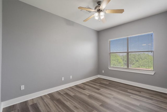 unfurnished room featuring ceiling fan, baseboards, and dark wood-style flooring