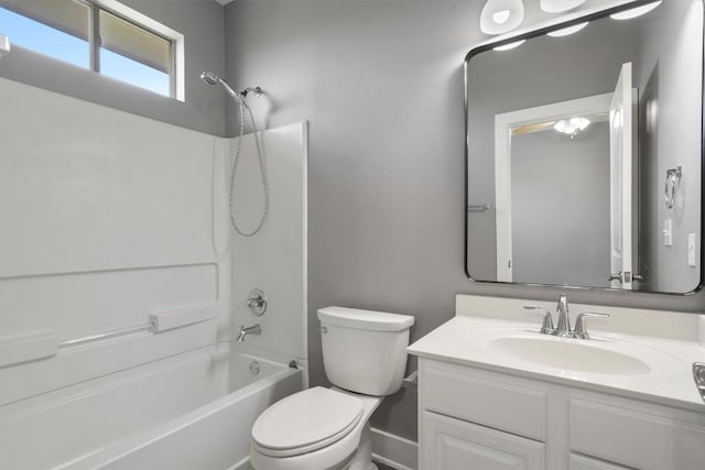 full bath featuring toilet, vanity, bathtub / shower combination, and baseboards