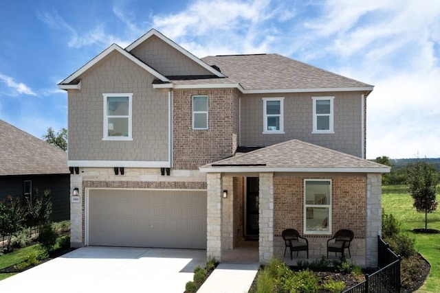 1100 Cole Estates Dr, Georgetown, TX 78628 - view of front of house with an attached garage, a shingled roof, driveway, and stone siding