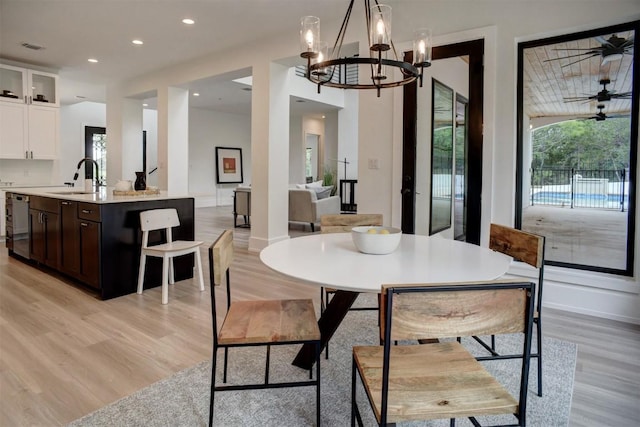 3018 Fm 535th Rd, Red Rock, TX 78662 - dining space featuring light wood finished floors, a chandelier, recessed lighting, and baseboards