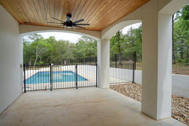 view of patio with a fenced in pool, a ceiling fan, and fence