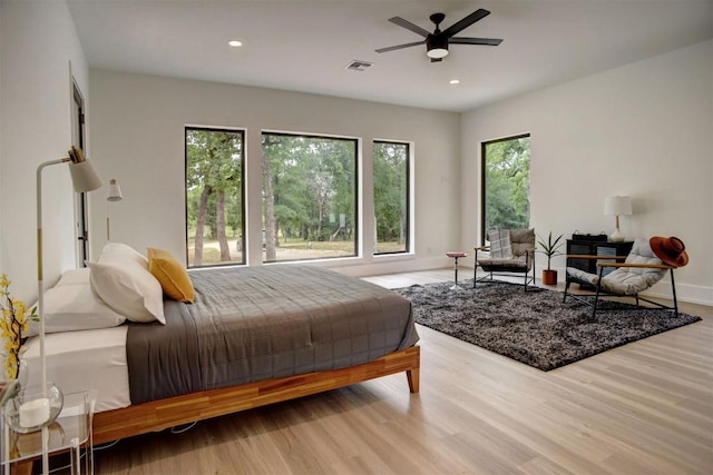 bedroom with recessed lighting, wood finished floors, visible vents, and baseboards