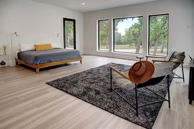 bedroom featuring recessed lighting, wood finished floors, access to exterior, and baseboards