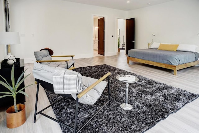 bedroom with wood finished floors and baseboards