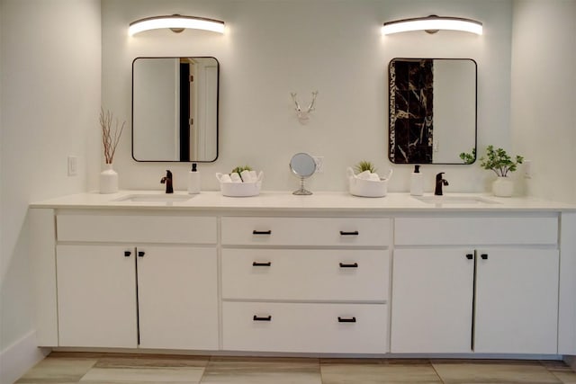 bathroom featuring a sink and double vanity
