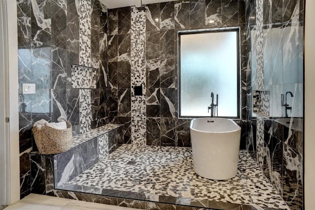 bathroom featuring a soaking tub, tile walls, and tiled shower