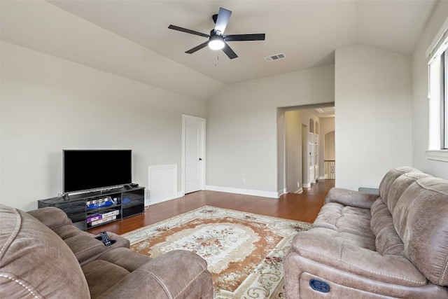 living area with vaulted ceiling, baseboards, visible vents, a ceiling fan, and wood finished floors