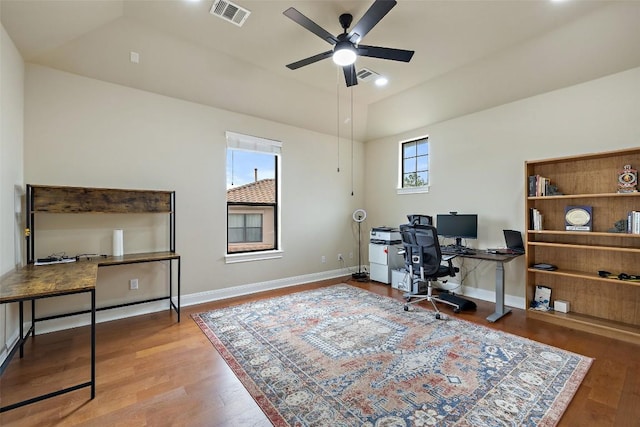 office featuring vaulted ceiling, wood finished floors, ceiling fan, baseboards, and visible vents